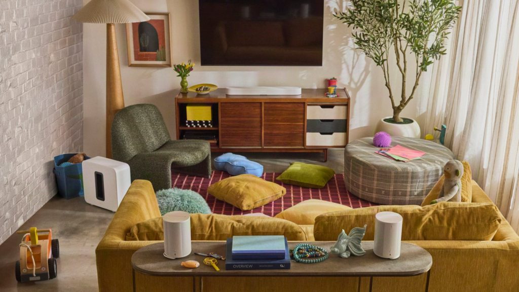 Sonos Beam Ultra soundbar under a TV with a Sonos subwoofer and rear speakers in a living room